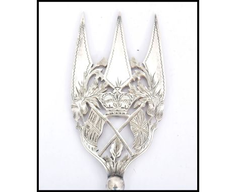 An unusual 19th century silver plated bread fork being pierced and engraved with royal crown and twin flags of the united kin