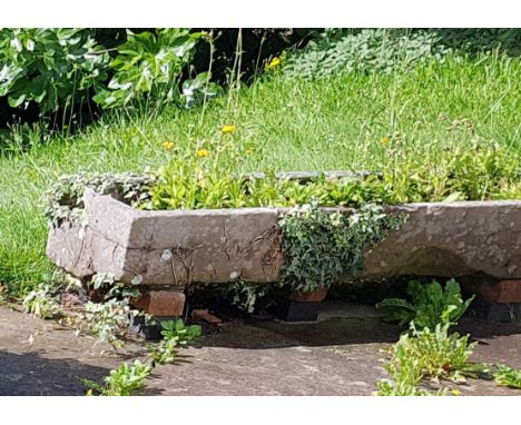A large antique 19th century long&nbsp; natural stone trough of rectangular shaped form being hewn hand carved being well wea