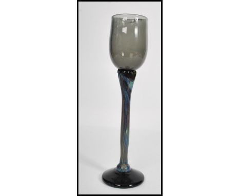 A vintage mid 20th century studio art wine glass raised on circular base with long coloured stem and smokey glass bowl. Signe