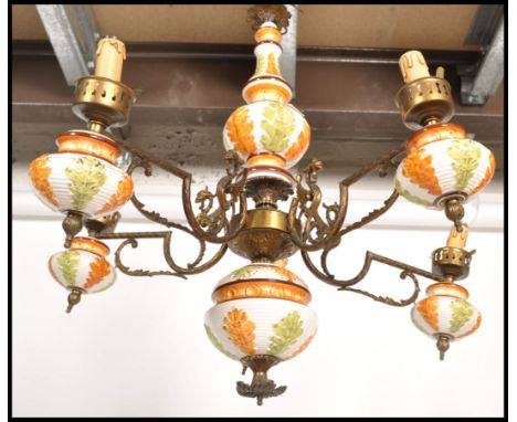 A 20th century Continental five branch brass / ormolu and ceramic light / chandelier light fixture, each branch having a deco