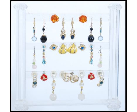 A large collection of costume jewellery earrings to include yellow and white metal examples being stone set, enamel set, glas