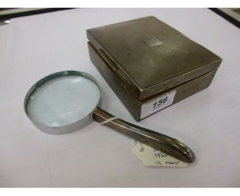 A silver cigarette box, having an engine turned, flush fitting hinged lid and cedar lined interior  4.5''w; and a silver hand