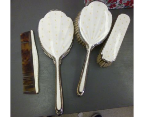 A Victorian style four piece silver and enamel backed dressing table set, viz. a comb, two brushes and a hand mirror  Birming