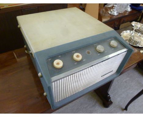 A 1960s His Masters Voice record player, the deck with auto-change, bass and treble adjustment, in a cream coloured and turqu