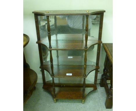 A modern mahogany, four tier, mirror backed hanging shelf with turned supports  26''h  19''w       SR