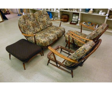 An Ercol four piece stained beech and elm suite  comprising a two seater settee and two open arm chairs, each having pierced 