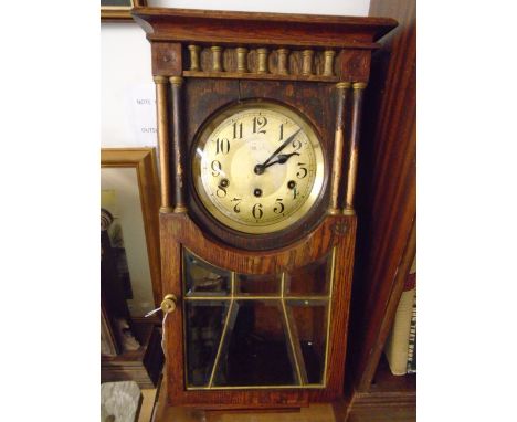 A CARVED OAK WALL CLOCK CHIMING ON STRIKER, 1/4 HOUR WITH ARABIC NUMBERS GLAZED DROP