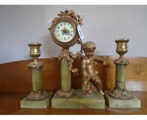 A FRENCH GARNITURE GREEN/BROWN STREAKED MARBLE WITH ORNATE GILDED CANDLES AND MATCHING MARBLE COLUMN SURROUND WITH CLOCK ENAM