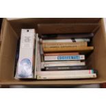 A box of various books including Fiction, Travel e