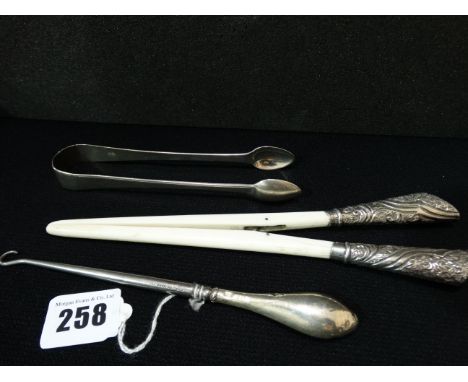 A Pair Of Silver Sugar Grips Together With A Silver Handled And Ivory Glove Stretcher And A Silver Handled Button Hook