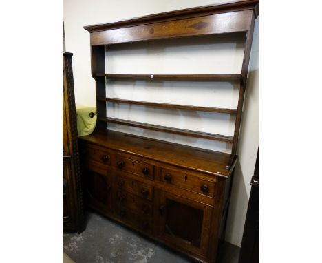 An Antique Oak And Mahogany Anglesey Dresser Having A Three Shelf Rack With Diamond And Dot Motif, The Base Of Typical Cupboa