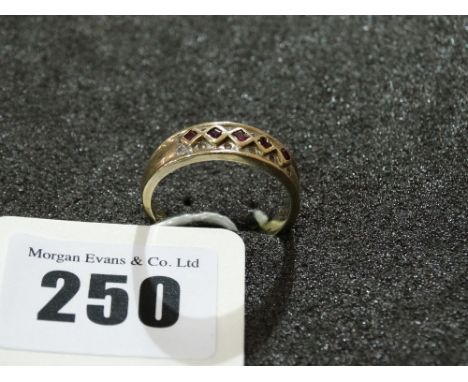 A 9 Carat Gold Diamond And Garnet Ring