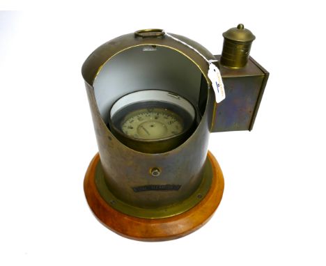 A gimballed maritime nautical compass, by Sestrel, housed in a brass case with 'The Maritime' plaque, mounted on a light timb
