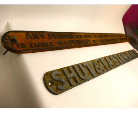 2 Cast Iron signs, 'Shut and Fasten Gate' measuring +/- 83cm long x 7cm wide and LNER 'Shut Gate Penalty' measuring +/- 101cm