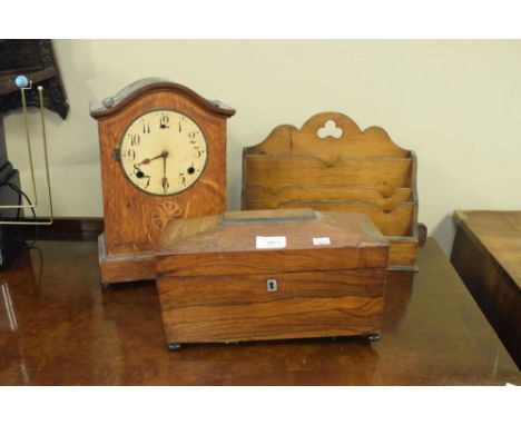 19th Century rosewood sarcophagus shaped tea caddy, an oak cased mantel clock and an Edwardian stationery rack  