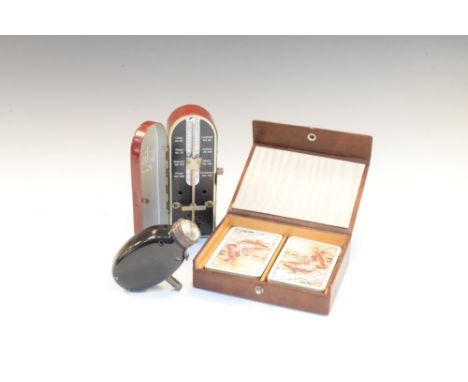Vintage Taktell Piccolo metronome, together with a hide playing card box decorated with a Tennis or Badminton player serving 