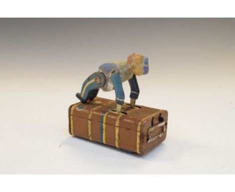 German Gescha clockwork tinplate hotel bellboy or porter, pushing a luggage trunk  