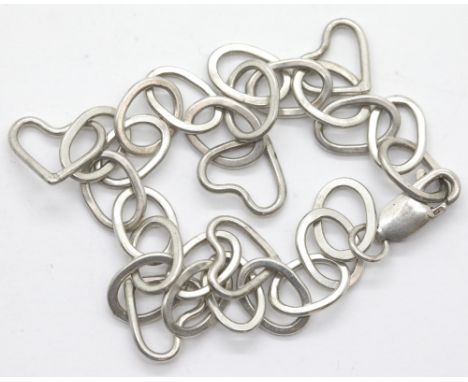 Silver vintage 1970s oval link bracelet with five heart charms. P&amp;P Group 1 (£14+VAT for the first lot and £1+VAT for sub