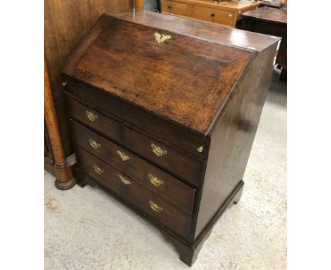 An 18th Century oak bureau, the plain top over a sloping fall enclosing a plain interior with pigeon holes and drawers over a