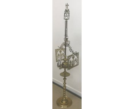 An unusual Middle Eastern brass eight light adjustable lamp with various integral accoutrements raised on a bobbin decorated 