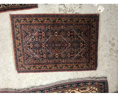 A Shenna rug, the central panel set with lozenge shaped medallion and all over stylised floral decoration on a red and blue g