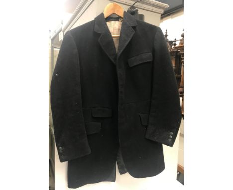 A vintage black hunting coat with plain black buttons, a pair of black leather riding boots and trees 29 cm long x 10.3 cm wi