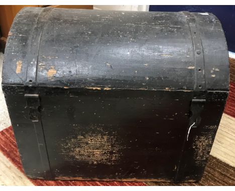 A 19th Century black painted pine dome top trunk, iron bound with hasp and staple lock plates and iron side carrying handles 