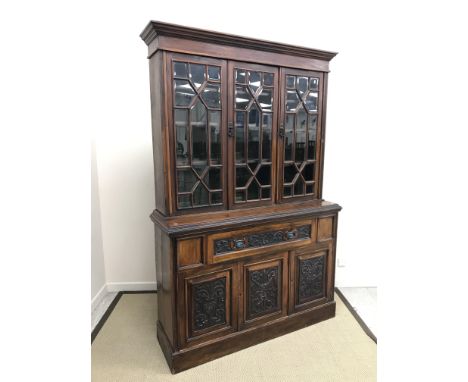 A Victorian walnut bookcase cabinet, the astragal glazed three door upper section enclosing adjustable shelving and with beve