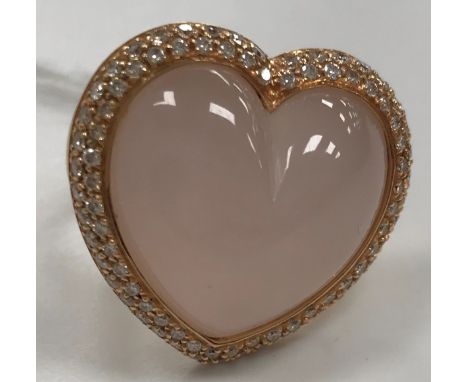 A modern 18 carat gold and rose quartz and diamond mounted ring of loveheart form, UK ring size P CONDITION REPORTS Over all 