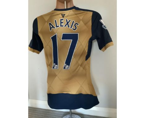 Alexis Sanchez 2015/2016 Match Worn Arsenal Away Football Shirt: Gold and navy blue short sleeve shirt worn in a Premier Leag