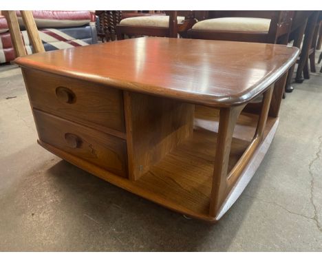 An Ercol Golden Dawn elm Pandora's box coffee table 