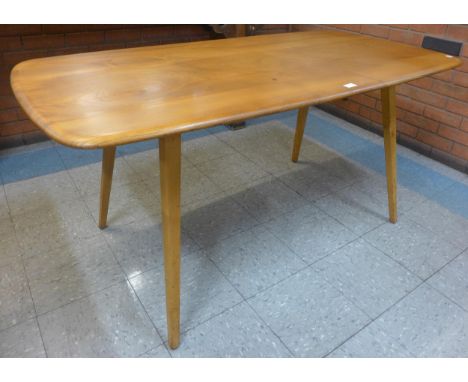 An Ercol Blonde elm and beech plank top Windsor dining table 