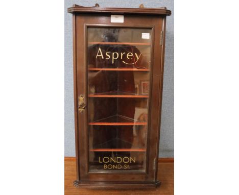 A mahogany display cabinet bearing Asprey inscription 