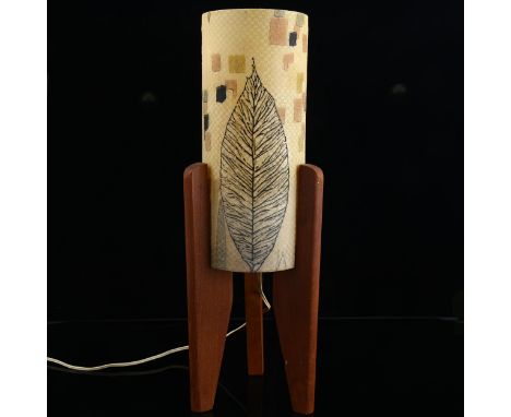 A 1960s rocket form table lamp, fibreglass shade with printed decoration on teak legs, height 43cm Some marks to shade, sligh
