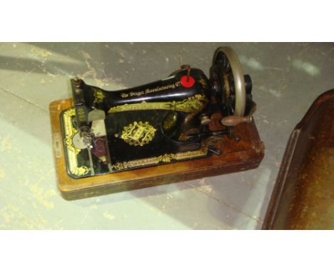 Vintage manual Singer sewing machine in wooden case