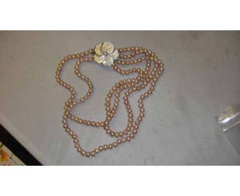 Triple pink pearl necklace with mother of pearl clasp 