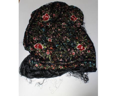 A late 20th century Japanese long fringed black shawl with pink peonies and other trailing flowers. 130 x 130cm excluding fri