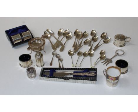 A collection of silver and EPNS to include spoons, napkin rings, beaker holders, a cruet, a toasting fork, a butter knife. To