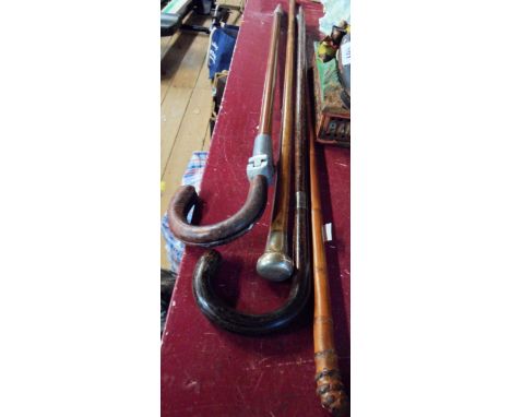 A silver topped walking cane and a similar cane with silver collar - sold with a further walking cane and a vintage shooting 