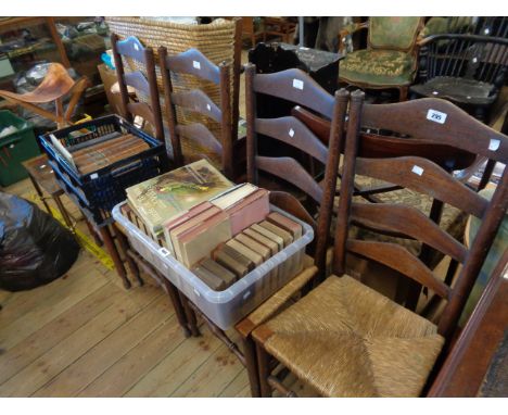 A set of four old oak framed ladder back chairs with woven rush seats, set on turned supports