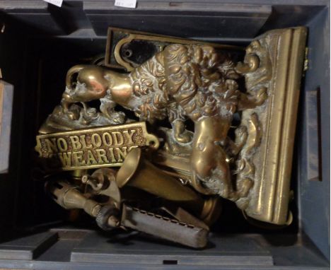 A small crate containing a quantity of assorted brassware including blow lamp, lion mantle ornaments, assorted signs, shell c