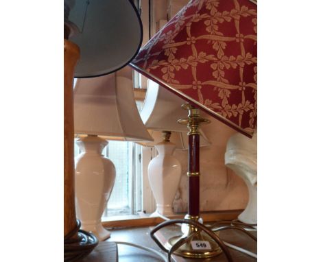 A pair of pink pottery table lamps - sold with a brass candle form table lamp with red painted highlighting