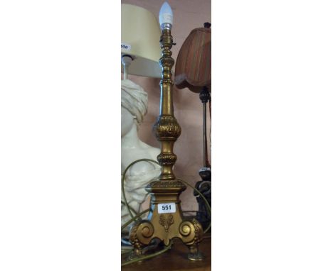 A cast brass table lamp of column form with three footed base