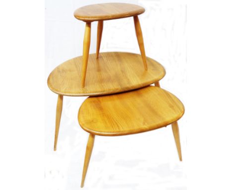 A nest of three Ercol light elm pebble tea tables, set on slender turned supports - no labels