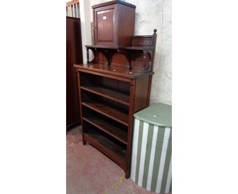 A 93cm early 20th Century Arts and Crafts style stained oak four shelf open bookcase with central panelled cupboard to supers