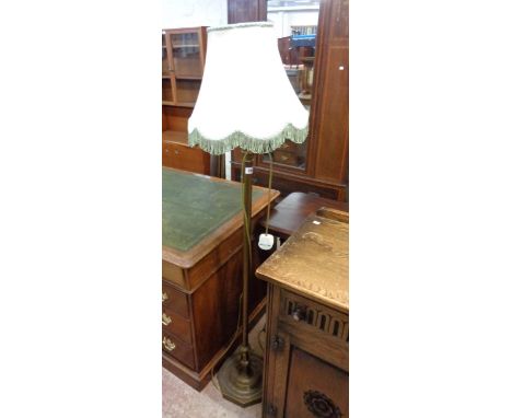 A reproduction brass three light standard lamp with central shade