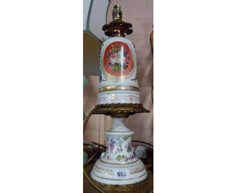 A late 19th Century two part pottery and gilt metal oil lamp comprising pedestal base and sit-on reservoir, decorated with ha