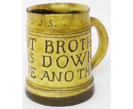 A 1930's Leach Pottery St Ives slipware mug decorated in the Michael Cardew manner with a drinking motto, with E.S. to J.S. i
