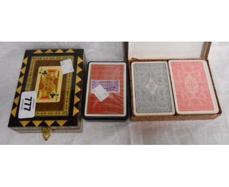 A vintage inlaid playing card box - sold with three sets of playing cards