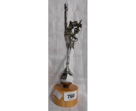 An Art Deco period chrome plated car mascot depicting Hermes stood with foot on a ball, mounted on later turned wood base